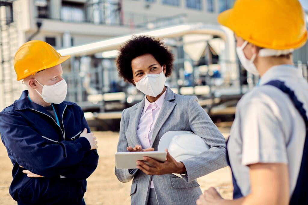african american building contractor talking civil engineers construction site coronavirus epidemic